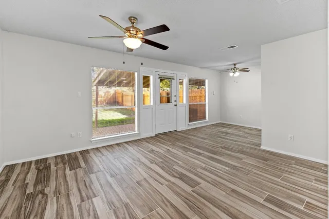 wooden floor in an empty room with a window
