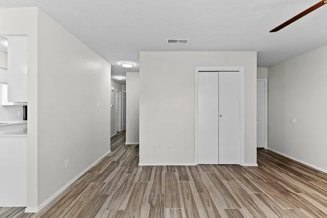 a view of hallway with wooden floor
