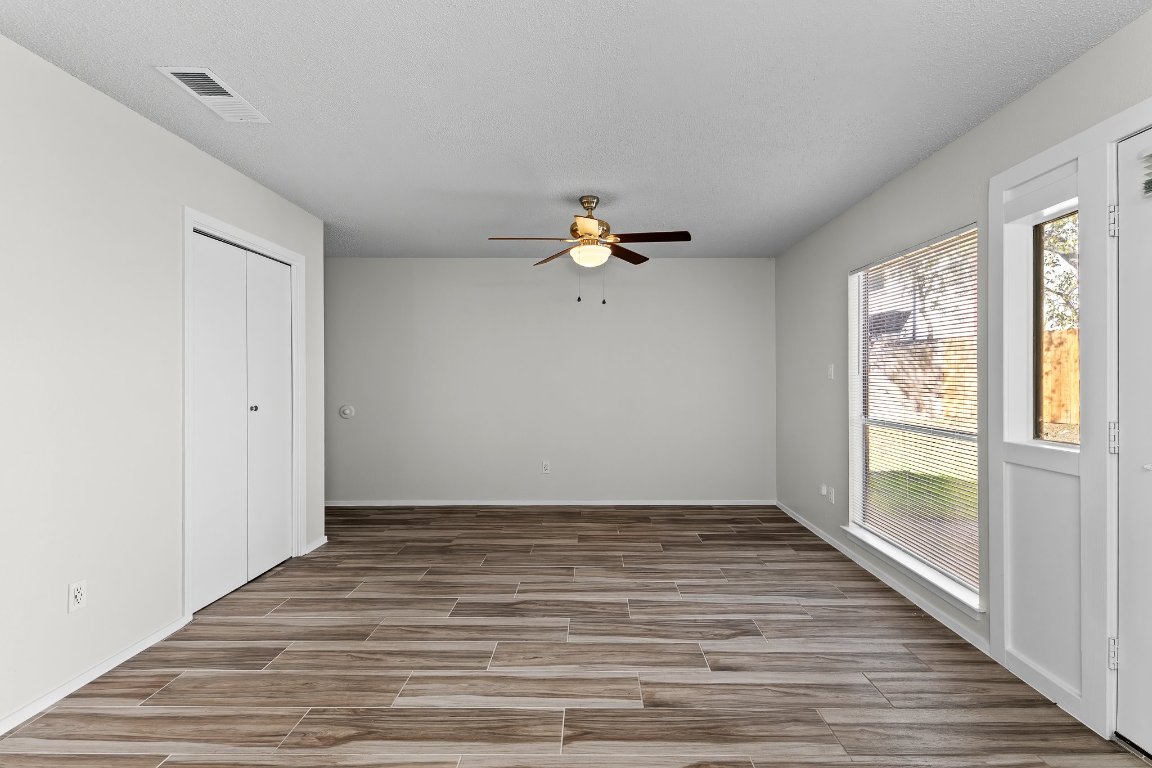 10807 Lambert Circle, Unit A Austin, TX 78758 - Photo 8 of 39 a view of a room with wooden floor and fan