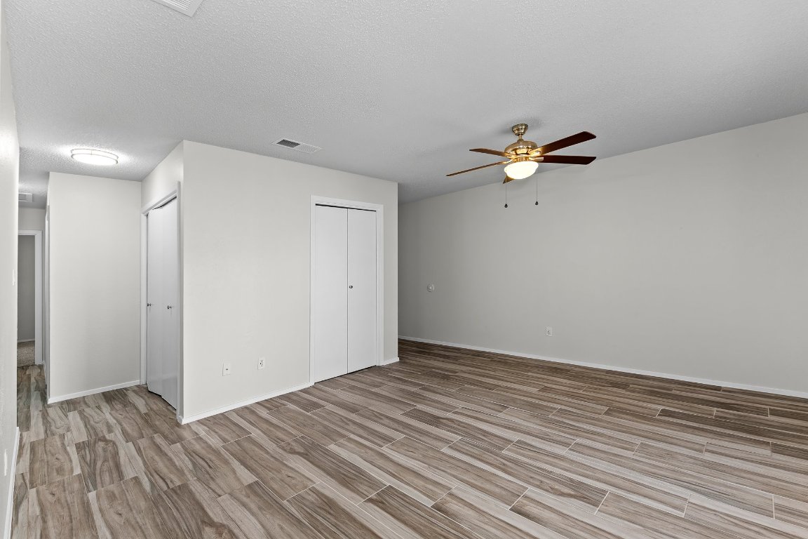 10807 Lambert Circle, Unit A Austin, TX 78758 - Photo 9 of 39 a view of an empty room with wooden floor