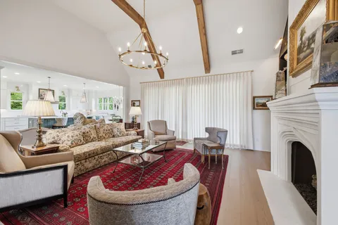 a living room with furniture and a floor to ceiling window