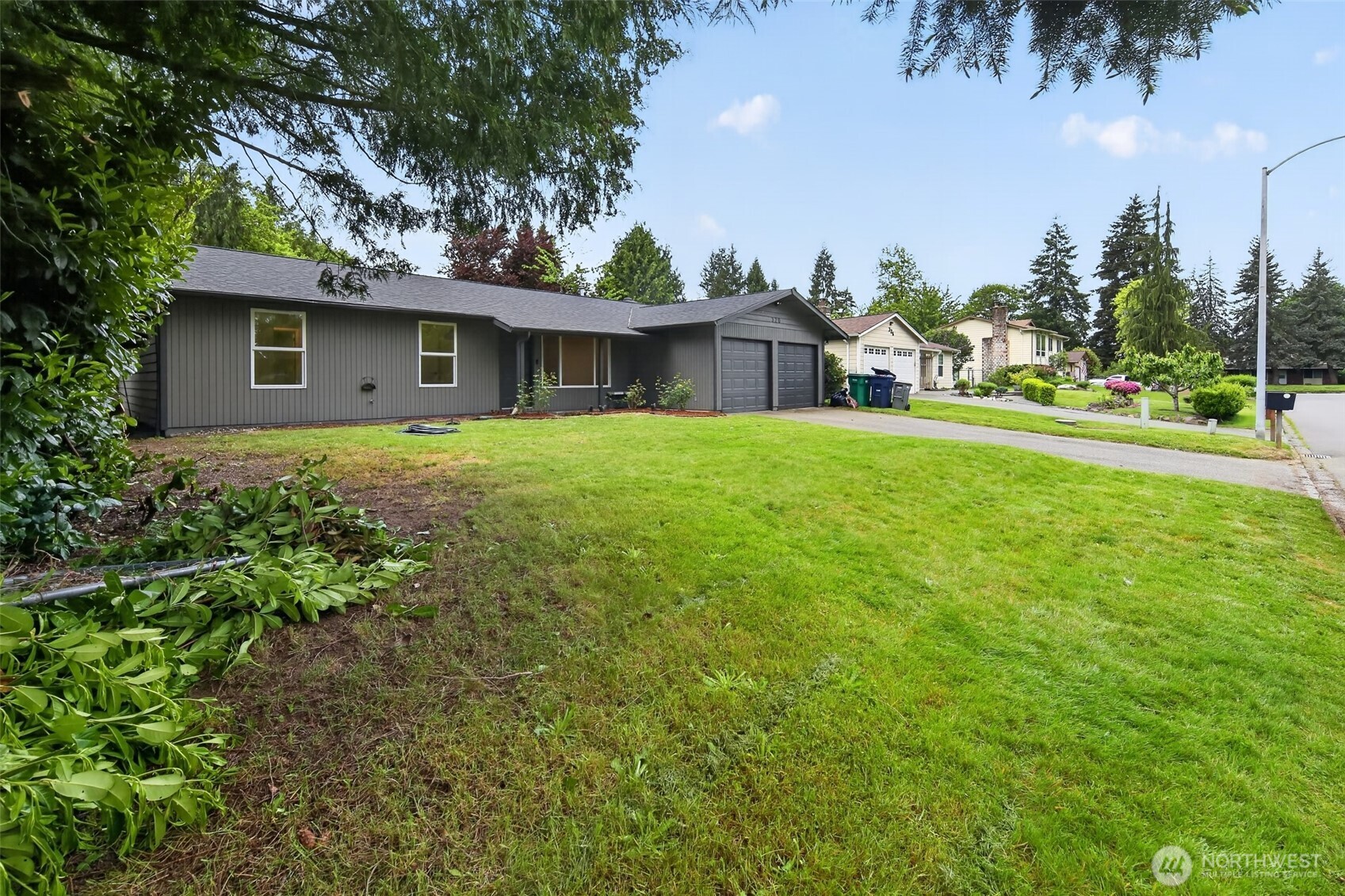 320 213th Place Southwest Bothell, WA 98021 - Photo 27 of 29 a front view of a house with garden
