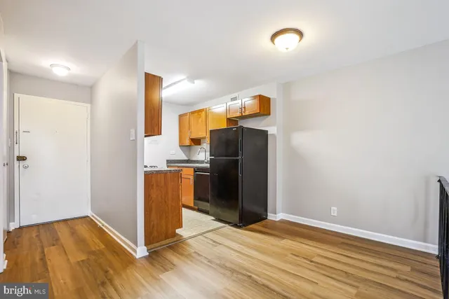 a view of empty room with wooden floor