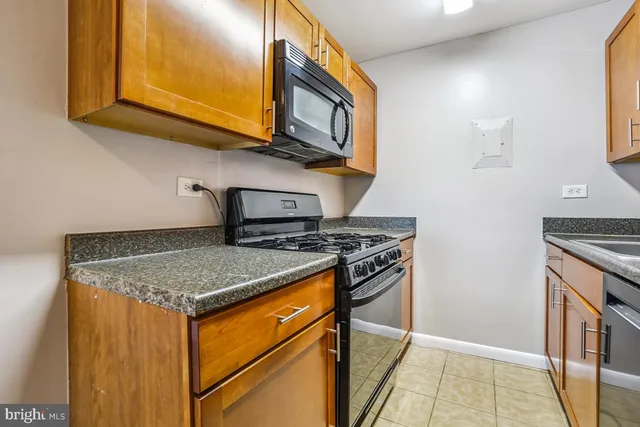 a kitchen with stainless steel appliances granite countertop a stove and a microwave