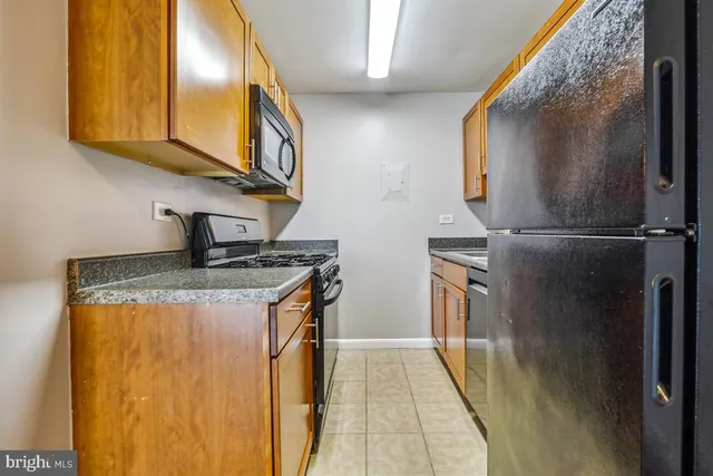 a utility room with wooden floor washer and dryer