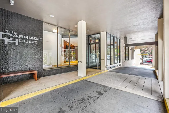 a spacious bedroom with a large window and a couch