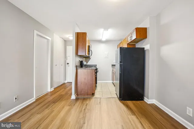 a view of kitchen with furniture and refrigerator