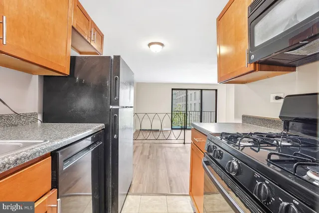 a kitchen with stainless steel appliances granite countertop a stove and a sink