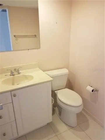 a white toilet sitting next to a bathroom sink