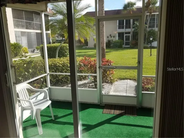 a view of a chair and tables in the balcony