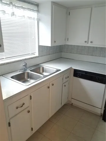 a kitchen with white cabinets and a sink