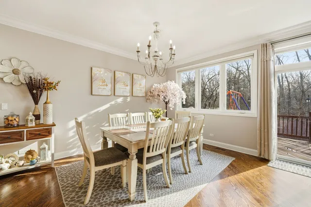 a view of a dining room with furniture a chandelier and wooden floor