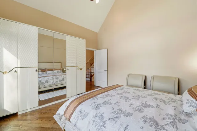 a bedroom with a large bed and a dresser