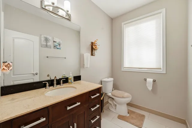 a bathroom with a sink a toilet and a mirror