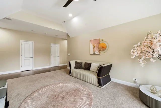 a bedroom with bed and white cabinets
