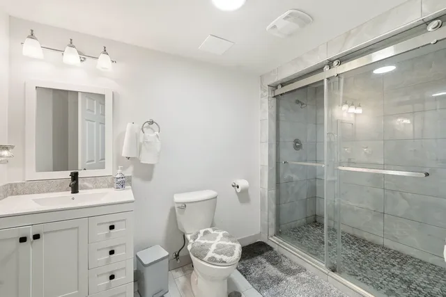 a bedroom with two beds and a desk