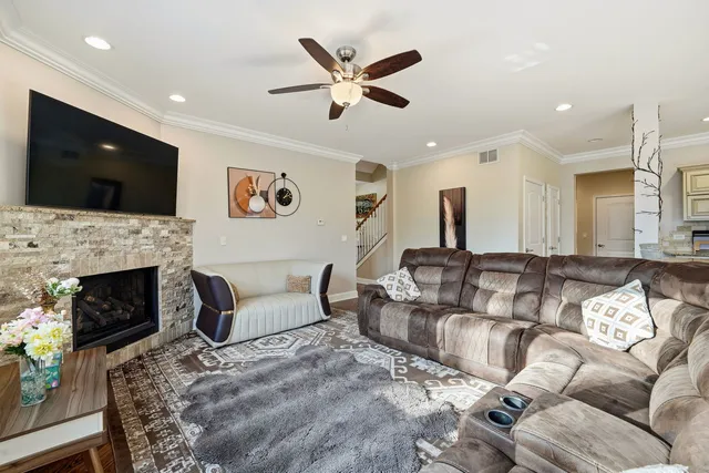 a living room with furniture a fireplace and a flat screen tv