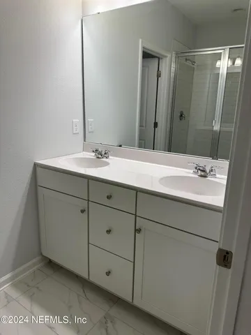 a bathroom with a sink and a mirror