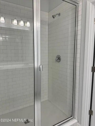 a bathroom with a glass shower door
