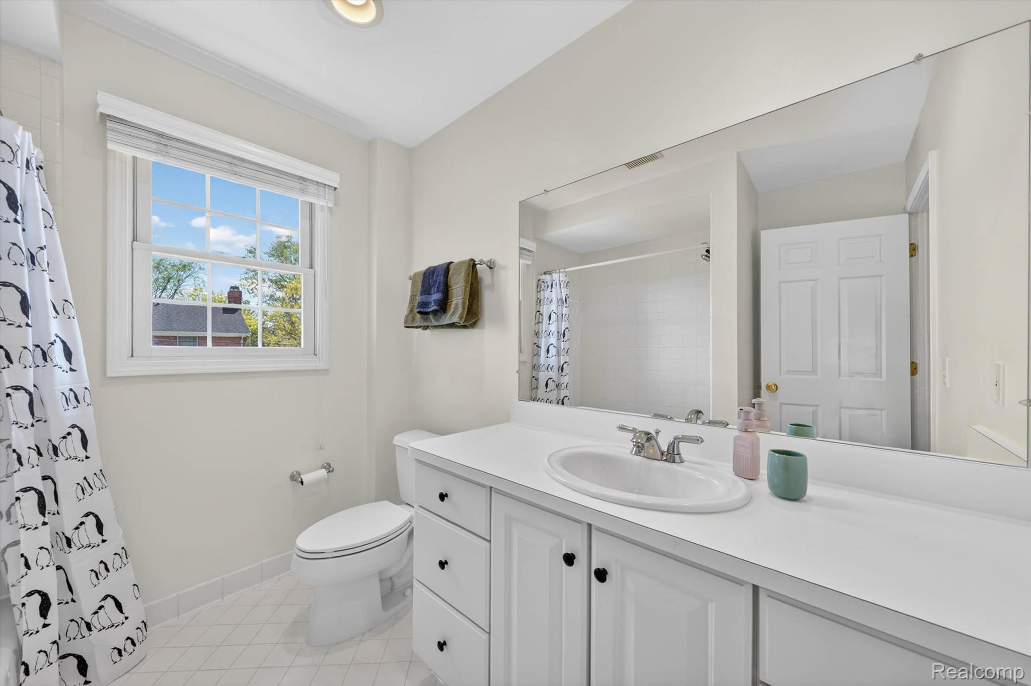 1112 Vernier Road Grosse Pointe, MI 48236 - Photo 24 of 39 Full bath with vanity, curtained shower, and light tile patterned floors