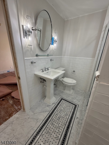 794 Lake Street Newark, NJ 07104 - Photo 2 of 9 a bathroom with a sink and a mirror