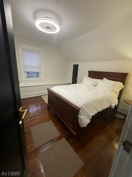 794 Lake Street Newark, NJ 07104 - Photo 3 of 9 a bedroom with a bed and a lamp with the wooden floor