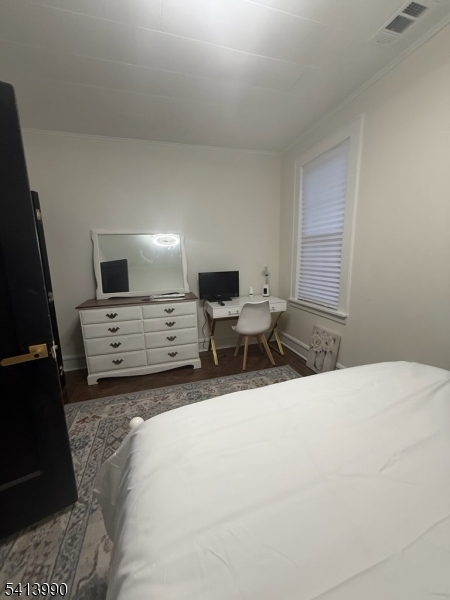 794 Lake Street Newark, NJ 07104 - Photo 8 of 9 a room with a bed a chair and glass door