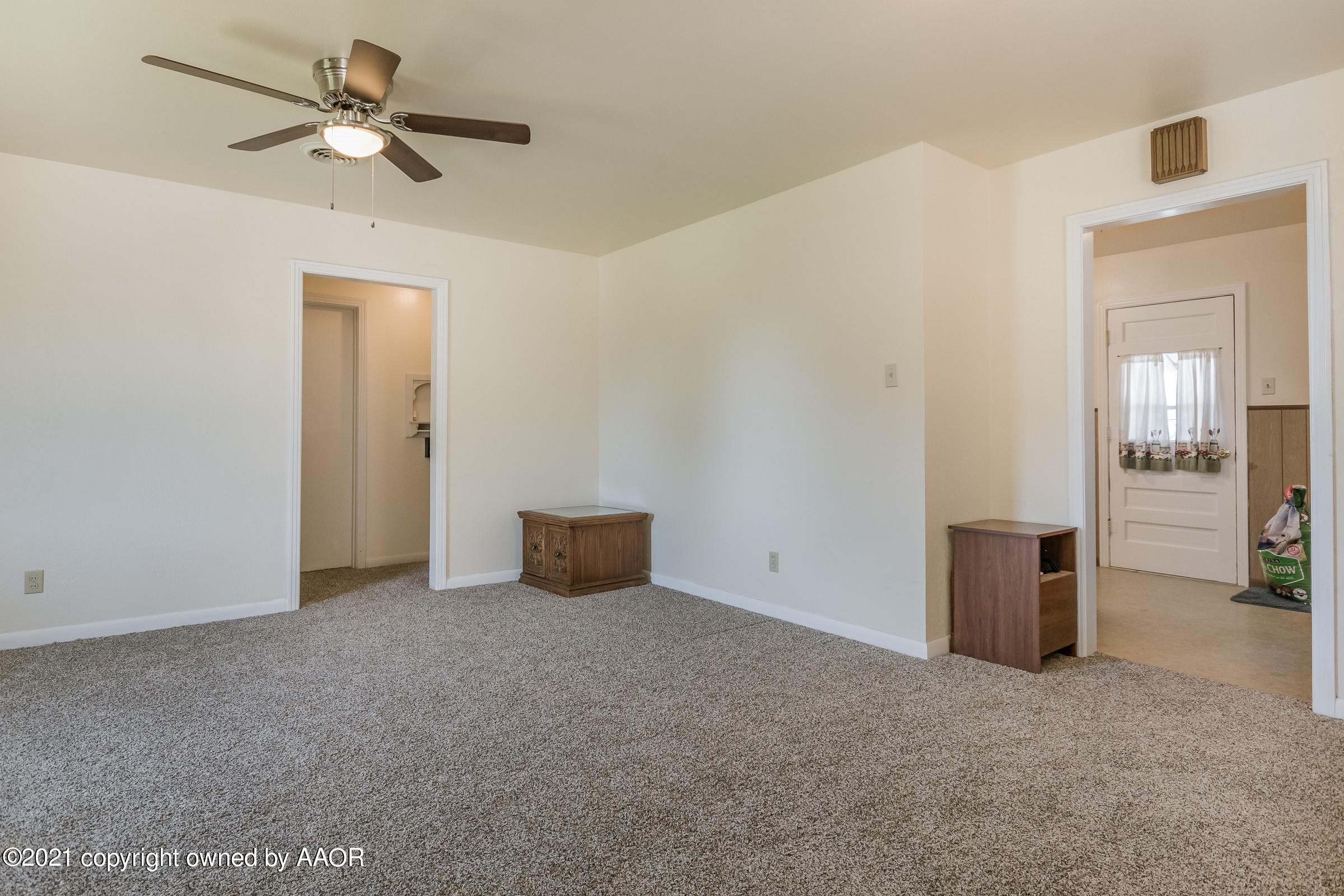 4412 South Lipscomb Street Amarillo, TX 79110 - Photo 3 of 18 a view of an empty room with a ceiling fan