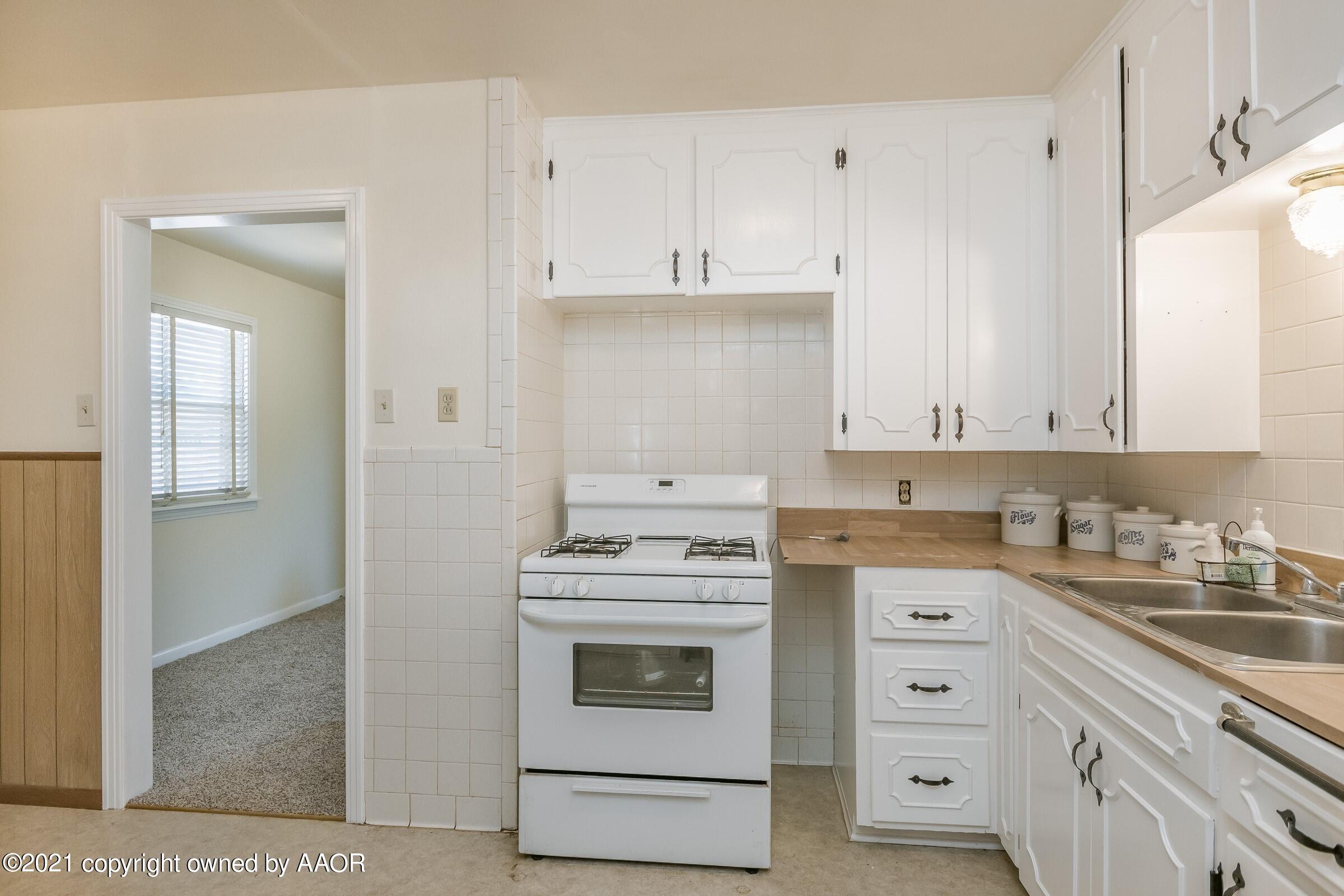 4412 South Lipscomb Street Amarillo, TX 79110 - Photo 6 of 18 a kitchen with cabinets appliances and a sink