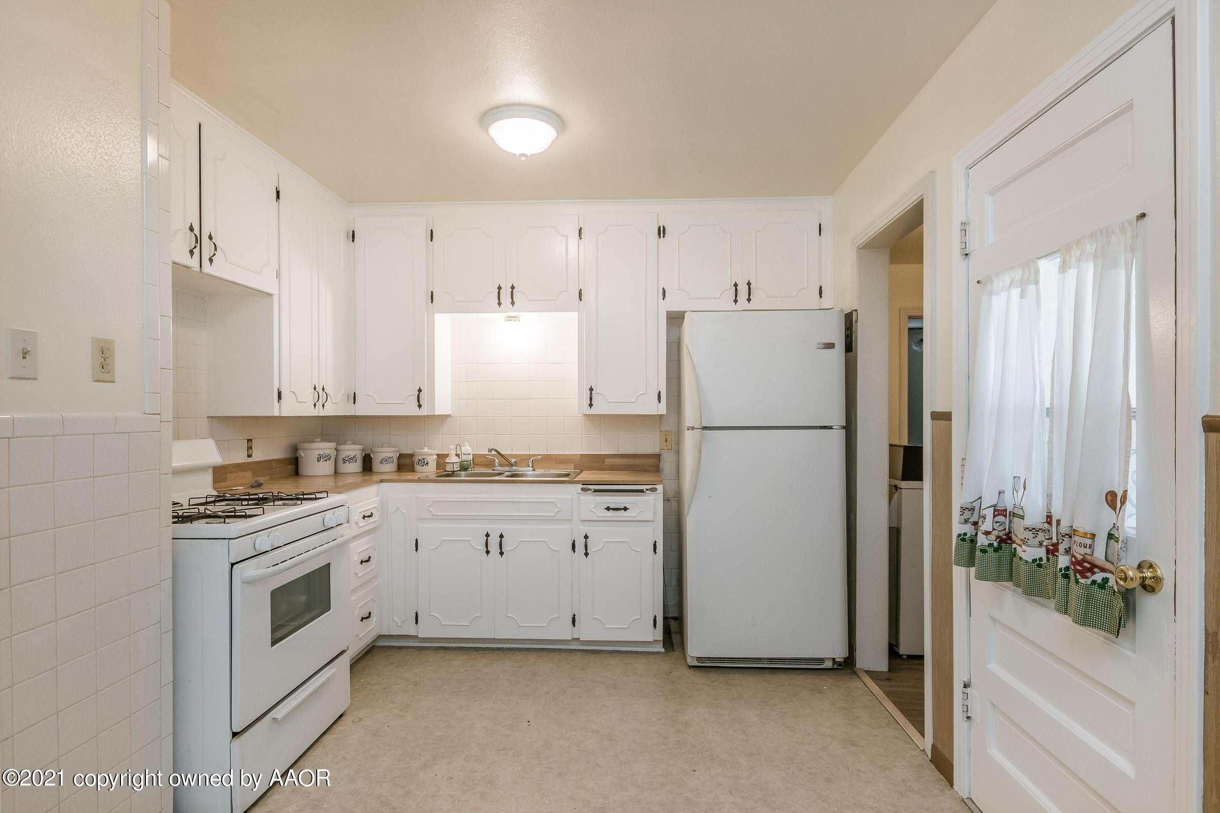 4412 South Lipscomb Street Amarillo, TX 79110 - Photo 7 of 18 a kitchen with white cabinets and white appliances