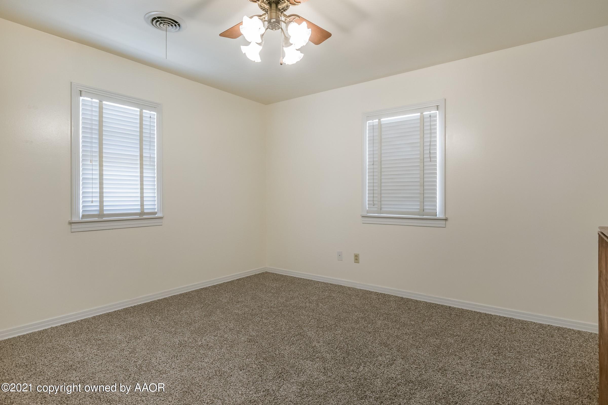 4412 South Lipscomb Street Amarillo, TX 79110 - Photo 10 of 18 an empty room with a chandelier fan and windows