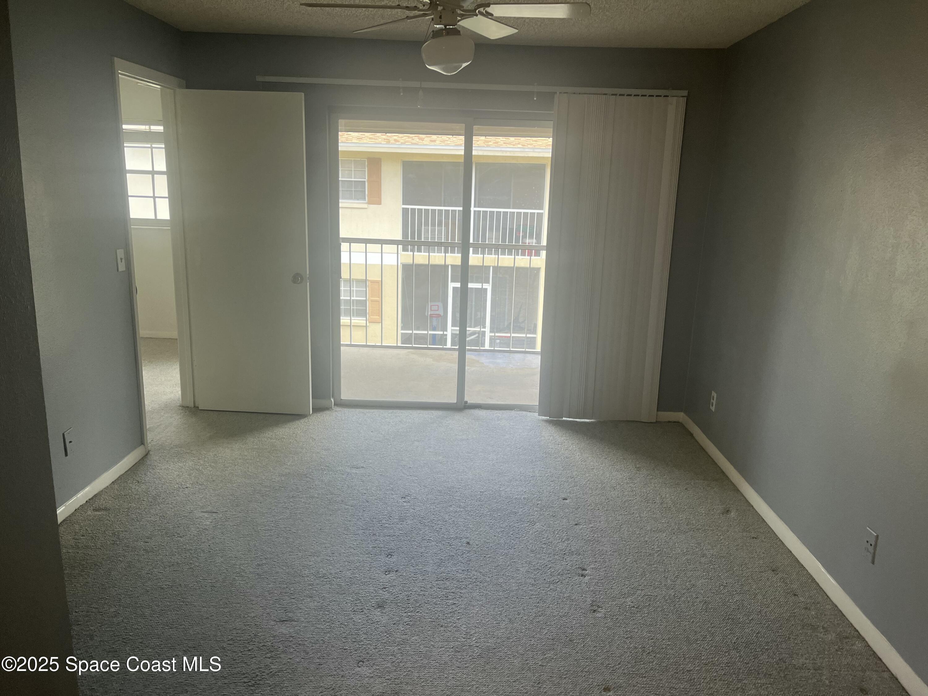 1624 Sunny Brook Lane, Unit C203 Palm Bay, FL 32905 - Photo 12 of 16 a view of an empty room with a window