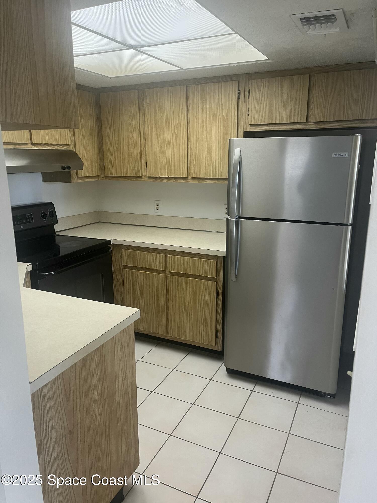 1624 Sunny Brook Lane, Unit C203 Palm Bay, FL 32905 - Photo 7 of 16 a kitchen with a refrigerator and a sink