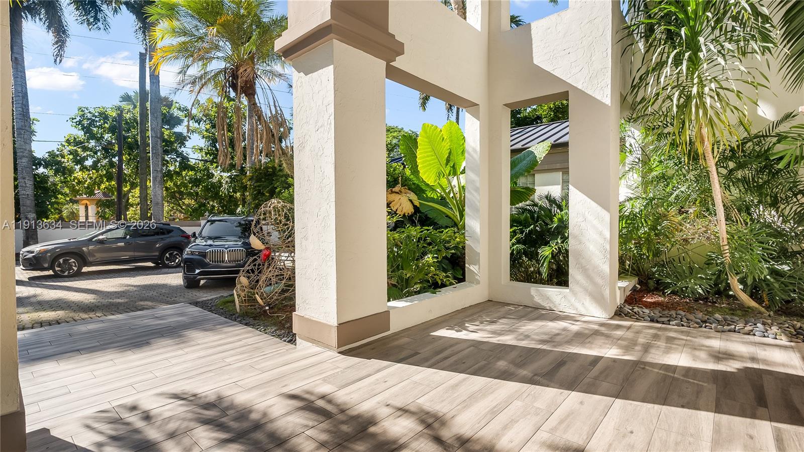 10395 Southwest 67th Avenue Pinecrest, FL 33156 - Photo 18 of 94 a view of a garden with cars parked