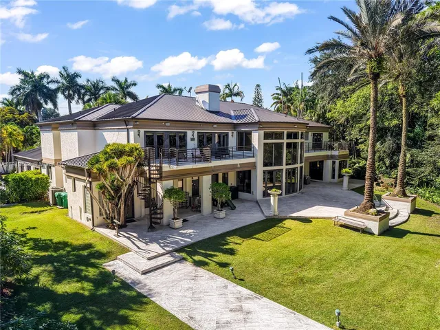 a view of a house with backyard porch and sitting area