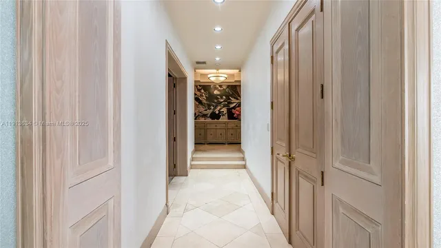 a kitchen with stainless steel appliances granite countertop a stove a refrigerator a oven with a dining table and chairs