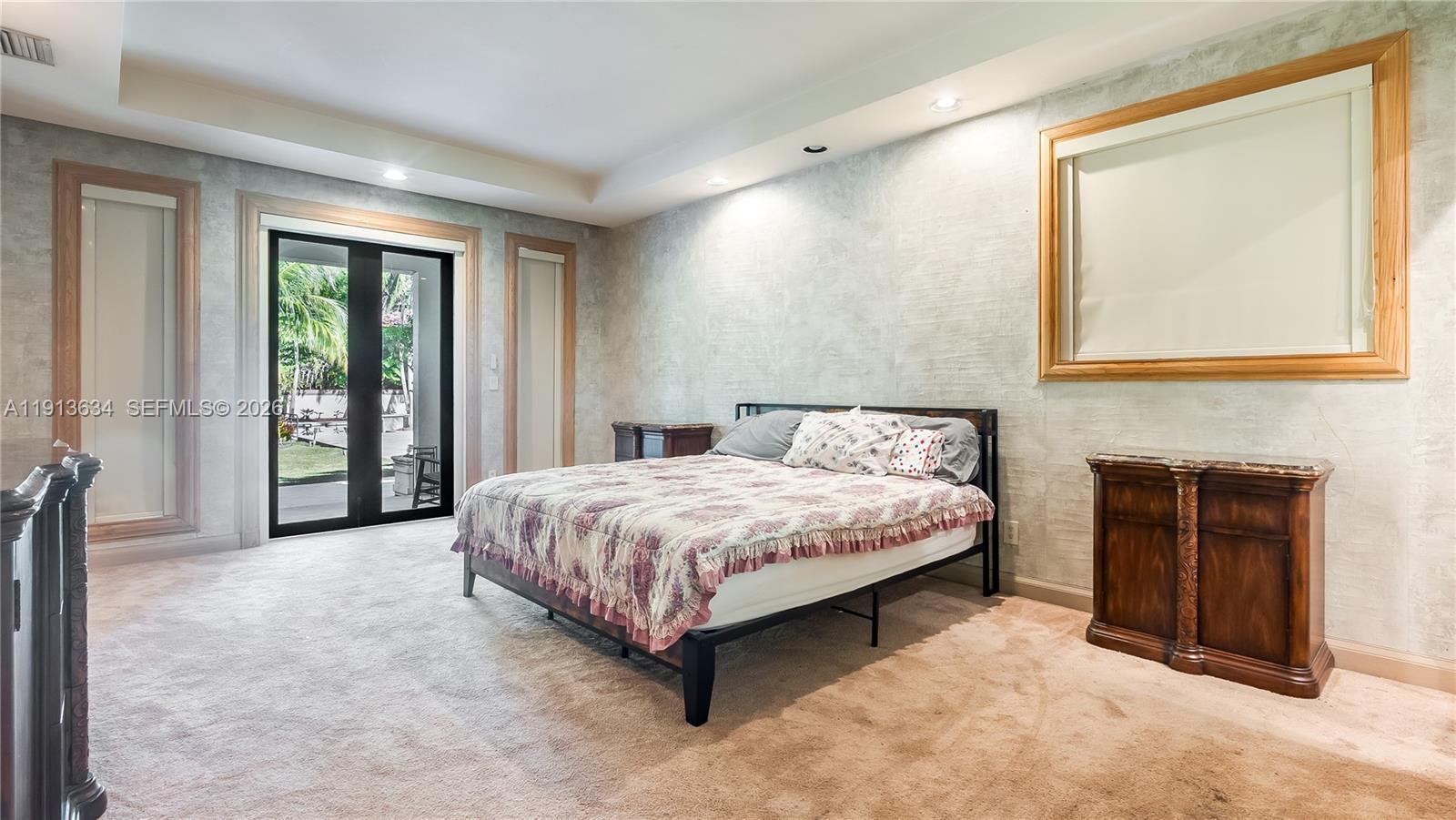 10395 Southwest 67th Avenue Pinecrest, FL 33156 - Photo 34 of 94 a spacious bedroom with a bed and a large window