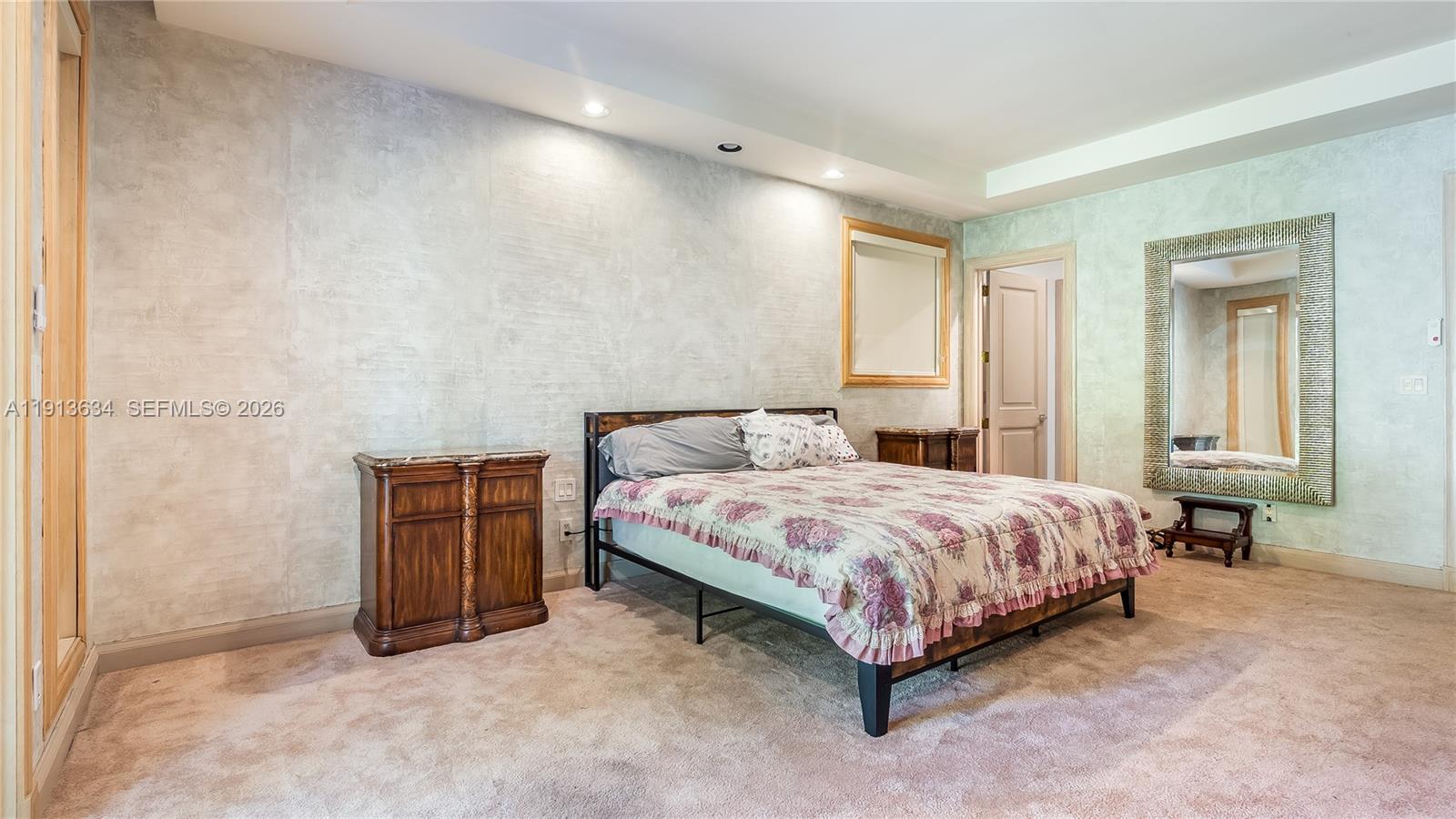 10395 Southwest 67th Avenue Pinecrest, FL 33156 - Photo 35 of 94 a spacious bedroom with a bed and a table