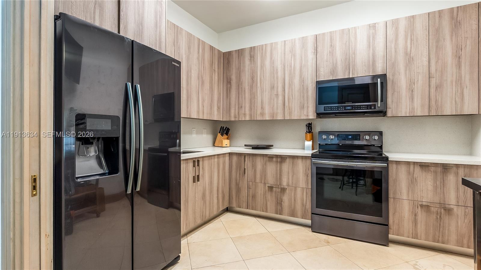 10395 Southwest 67th Avenue Pinecrest, FL 33156 - Photo 37 of 94 a kitchen with a refrigerator stove and microwave