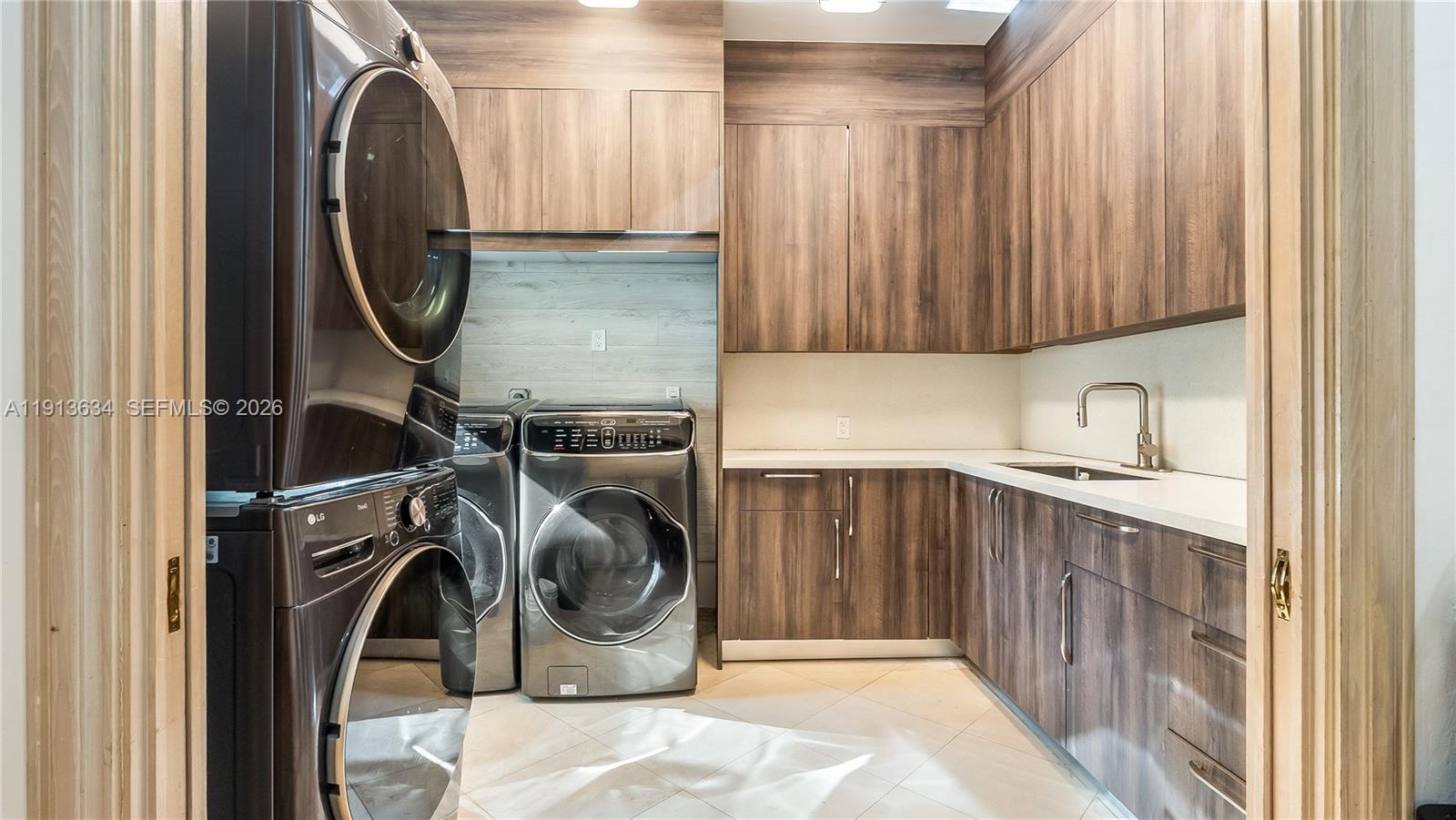10395 Southwest 67th Avenue Pinecrest, FL 33156 - Photo 38 of 94 a utility room with sink dryer and washer