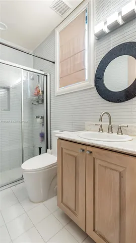 a bathroom with a shower and a sink