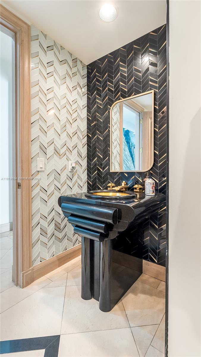 10395 Southwest 67th Avenue Pinecrest, FL 33156 - Photo 43 of 94 a bathroom with a sink and a mirror