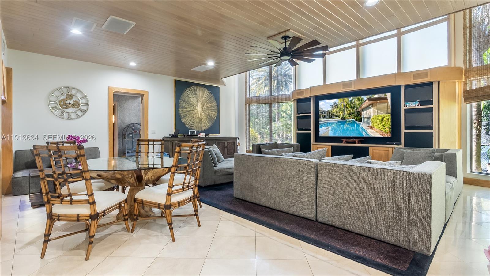 10395 Southwest 67th Avenue Pinecrest, FL 33156 - Photo 44 of 94 a living room with furniture a window and a flat screen tv