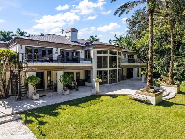 a front view of a house with a yard garage and outdoor seating