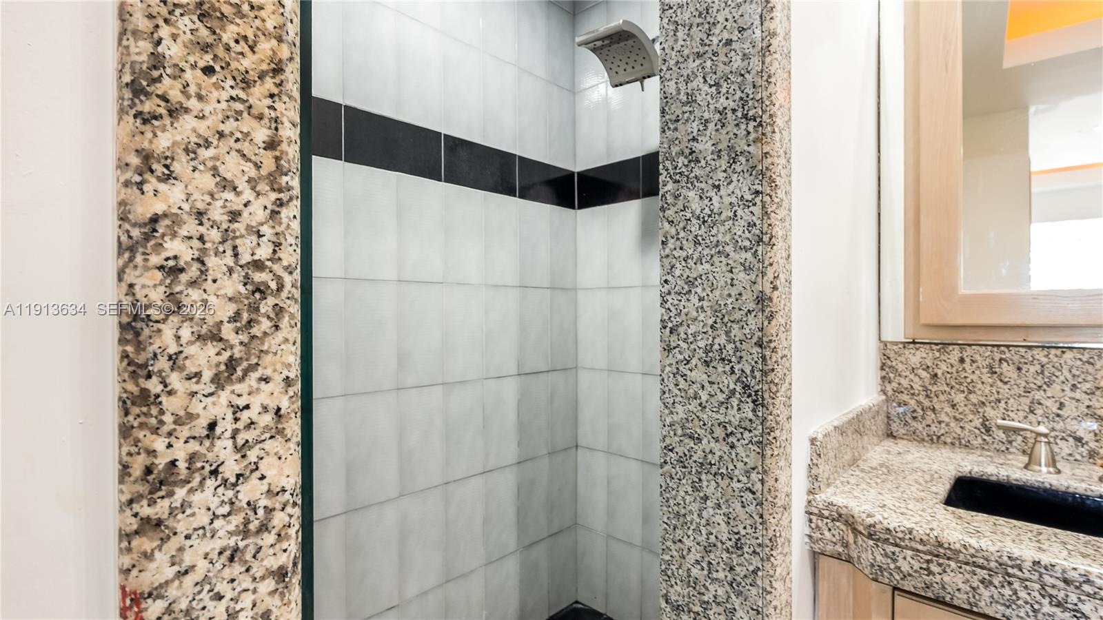 10395 Southwest 67th Avenue Pinecrest, FL 33156 - Photo 66 of 94 a bathroom with a shower and a sink