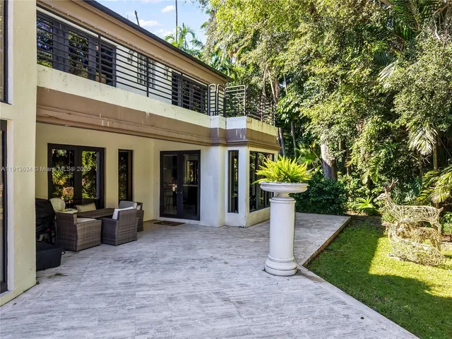 an aerial view of a house with yard swimming pool and outdoor seating