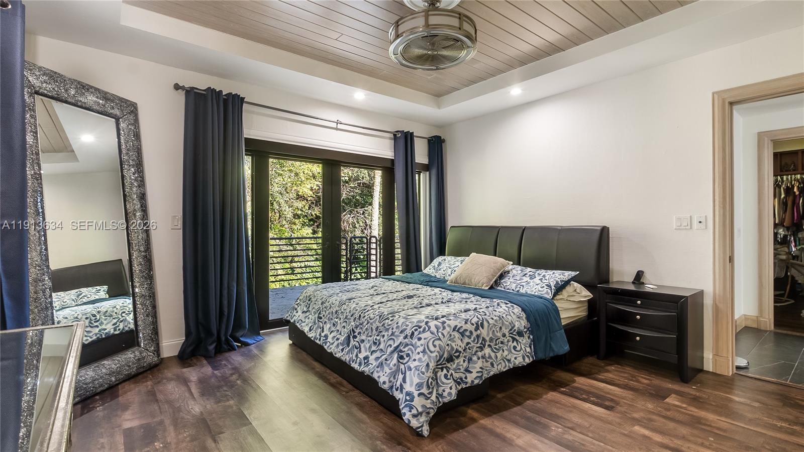 10395 Southwest 67th Avenue Pinecrest, FL 33156 - Photo 72 of 94 a bedroom with a large bed and a window