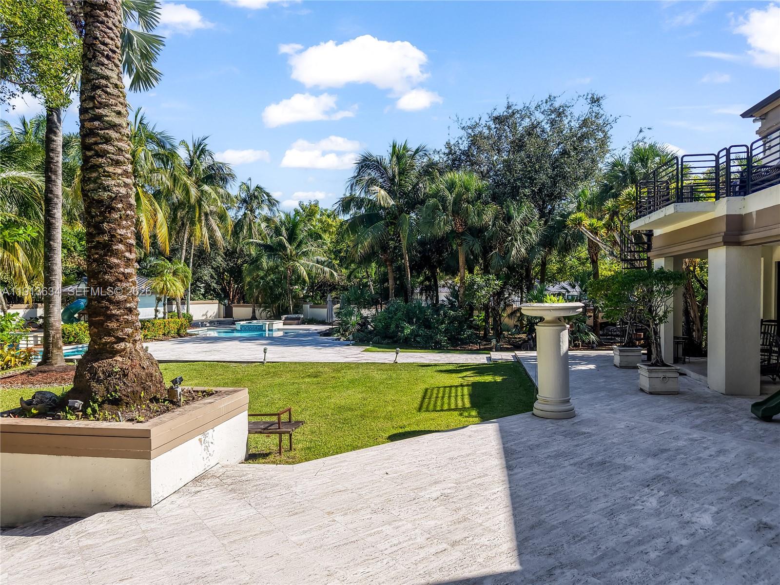 10395 Southwest 67th Avenue Pinecrest, FL 33156 - Photo 8 of 94 a view of a swimming pool with a patio