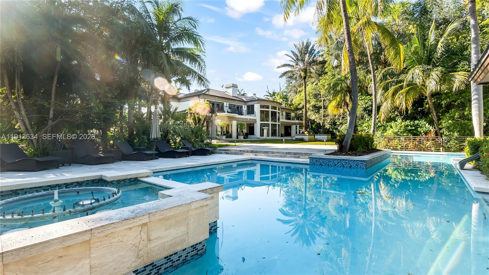 10395 Southwest 67th Avenue Pinecrest, FL 33156 - Photo 82 of 94 a view of a house with pool and sitting area