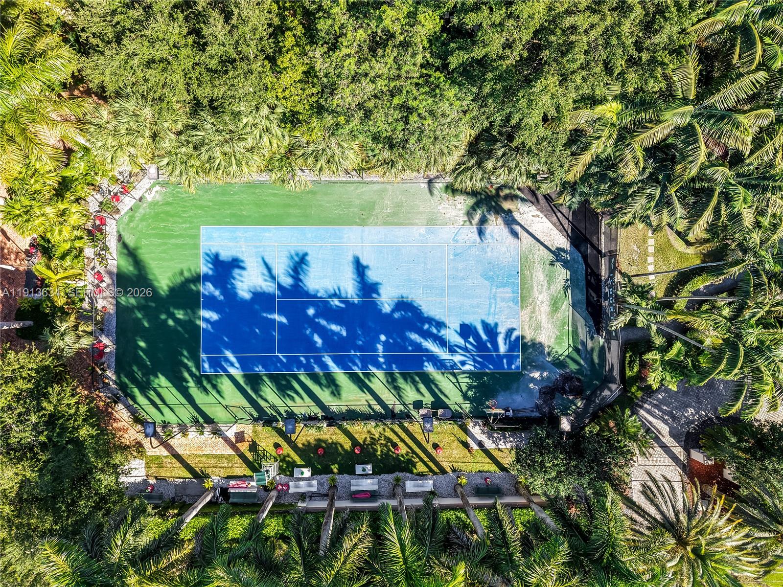 10395 Southwest 67th Avenue Pinecrest, FL 33156 - Photo 90 of 94 a view of a bench in a garden